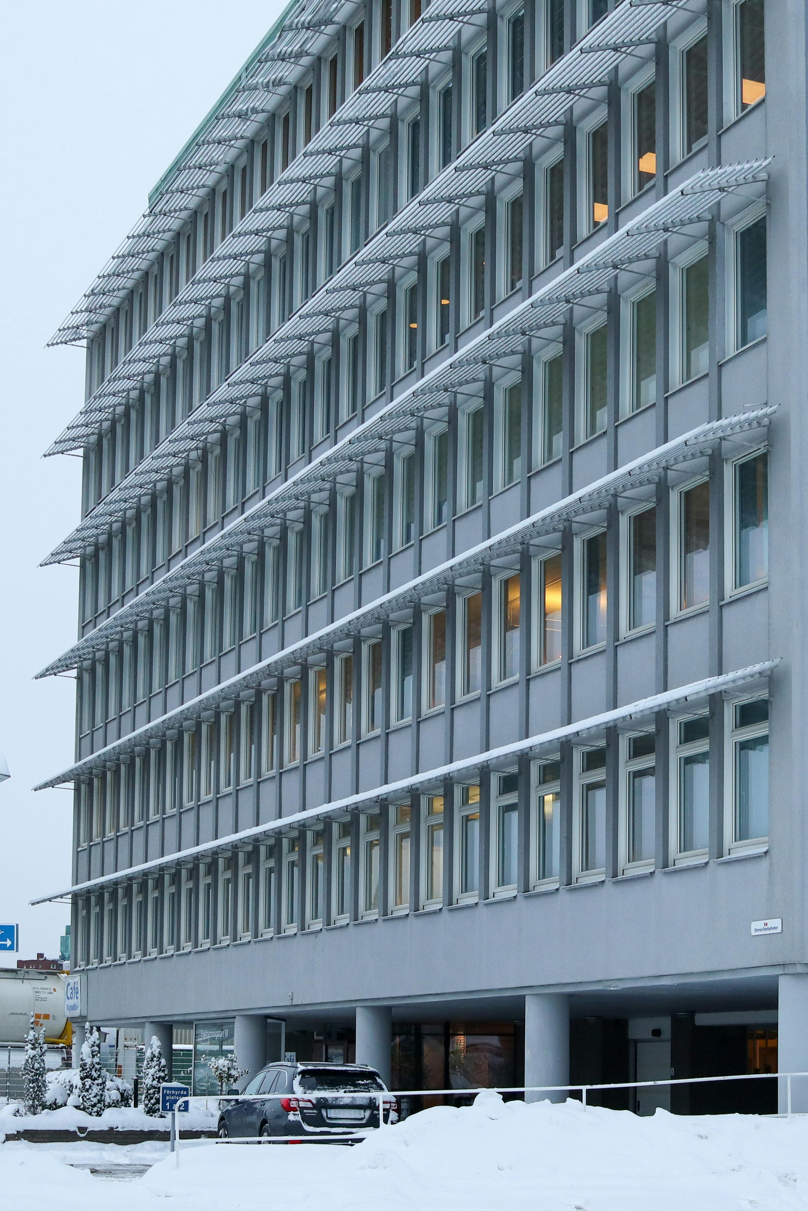 A Business building covered and surrounded by snow